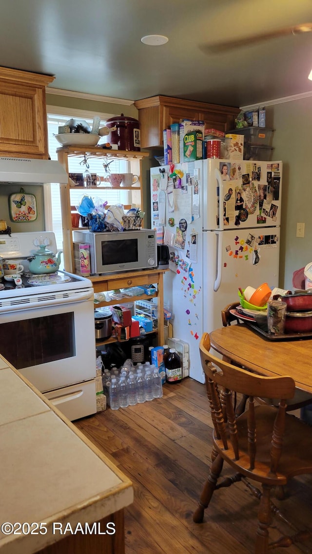 205 F St, Duson, LA 70529 - kitchen featuring crown molding, under cabinet range hood, white appliances, and wood finished floors