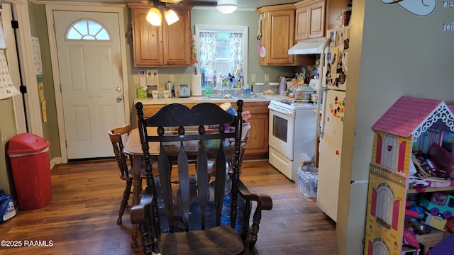 205 F St, Duson, LA 70529 - kitchen with under cabinet range hood, white stove, light countertops, and dark wood-type flooring
