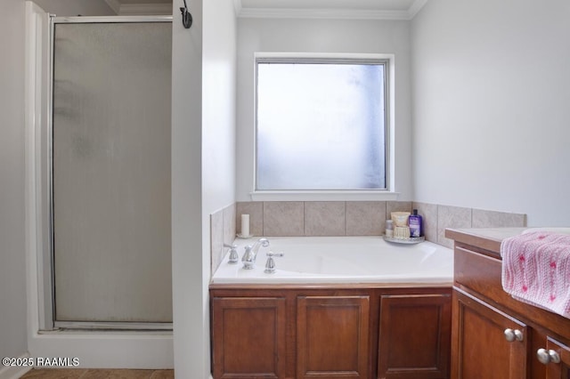 bathroom featuring ornamental molding, a garden tub, and a stall shower