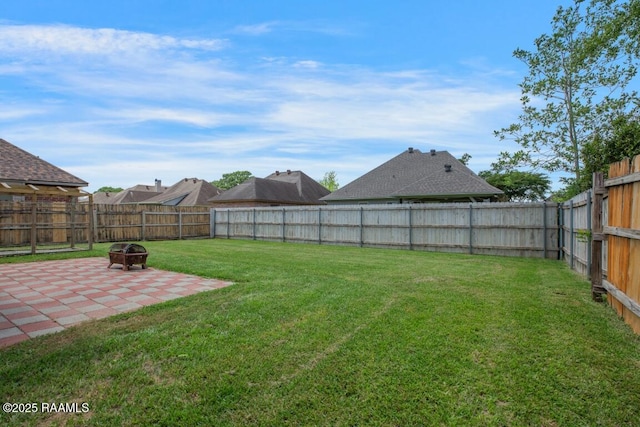 view of yard featuring a fenced backyard, a patio area, and an outdoor fire pit