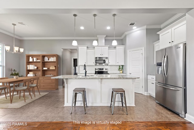 kitchen with stainless steel appliances, a sink, crown molding, tile patterned flooring, and tasteful backsplash
