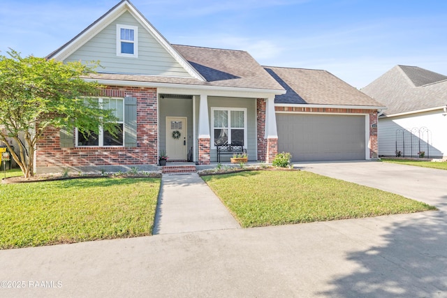view of front of house with brick siding, a porch, a garage, and a front yard