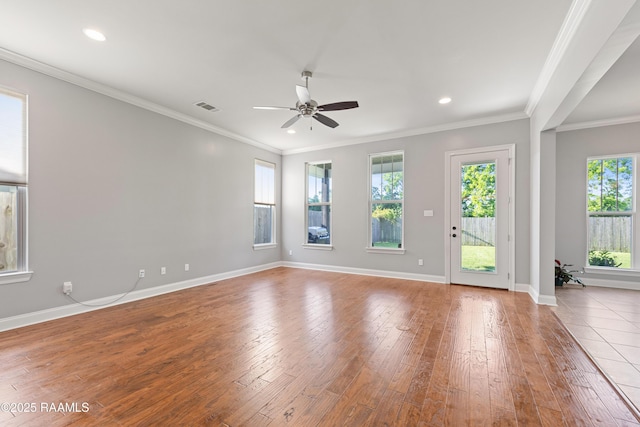 spare room with a ceiling fan, hardwood / wood-style flooring, baseboards, ornamental molding, and recessed lighting