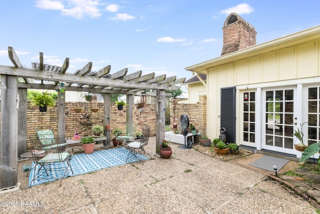 207 S Saint Valerie St, Abbeville, LA 70510 - view of patio / terrace featuring a pergola, fence, and french doors