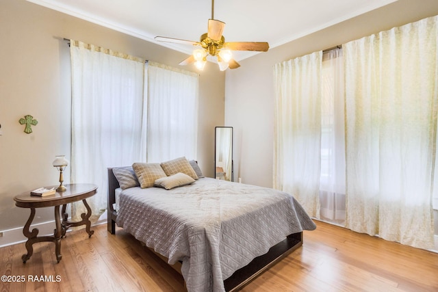 207 S Saint Valerie St, Abbeville, LA 70510 - bedroom with light wood-style floors, ornamental molding, and ceiling fan