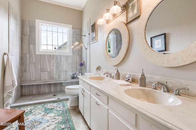 207 S Saint Valerie St, Abbeville, LA 70510 - bathroom with double vanity, a sink, a tile shower, and toilet