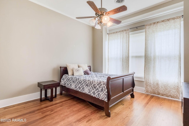 207 S Saint Valerie St, Abbeville, LA 70510 - bedroom featuring baseboards, ceiling fan, and light wood-type flooring
