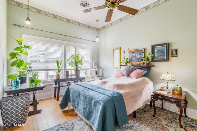207 S Saint Valerie St, Abbeville, LA 70510 - bedroom with baseboards, visible vents, and wood finished floors