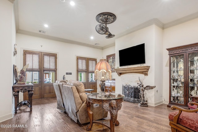 living room featuring wood finished floors, french doors, ornamental molding, recessed lighting, and baseboards