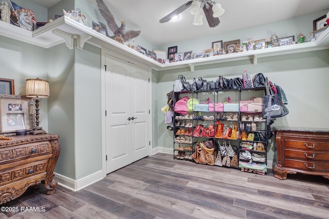 spacious closet with wood finished floors and a ceiling fan