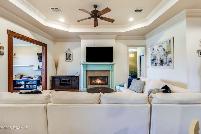 110 Beringer Dr, Duson, LA 70529 - living room with visible vents, ornamental molding, a glass covered fireplace, ceiling fan, and a raised ceiling