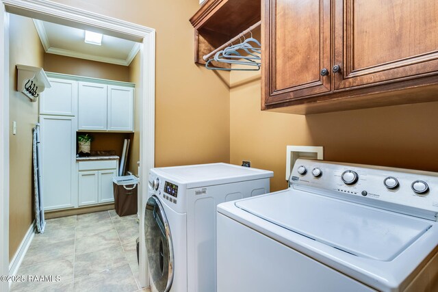 110 Beringer Dr, Duson, LA 70529 - clothes washing area with washing machine and clothes dryer, baseboards, ornamental molding, and cabinet space