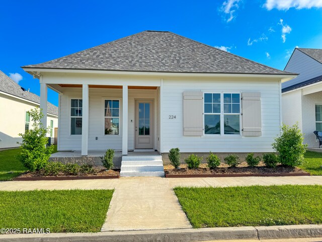 bungalow-style home with roof with shingles and covered porch