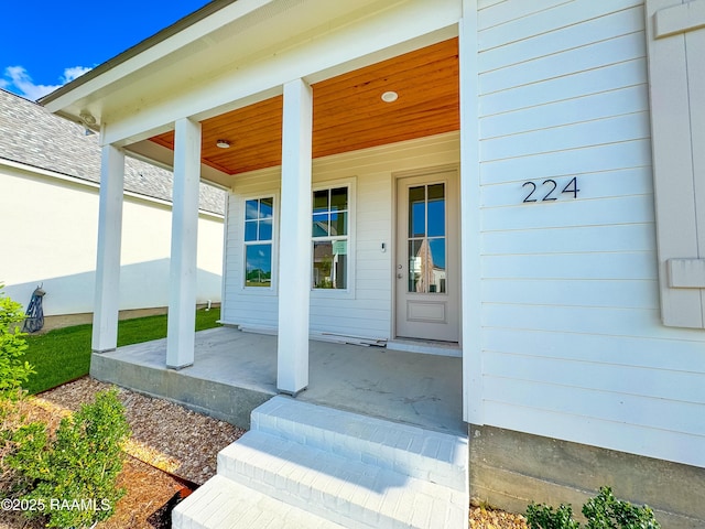 view of exterior entry with a porch