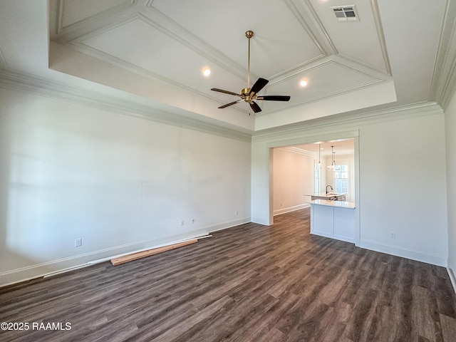 spare room with visible vents, coffered ceiling, crown molding, and dark wood finished floors
