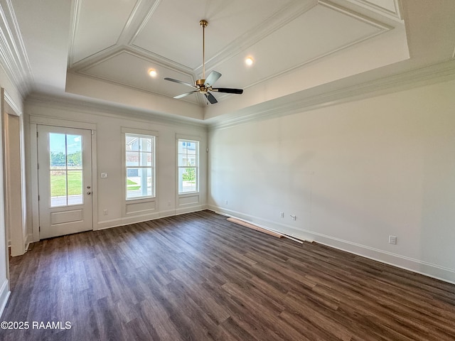 unfurnished room featuring a ceiling fan, dark wood finished floors, ornamental molding, and coffered ceiling