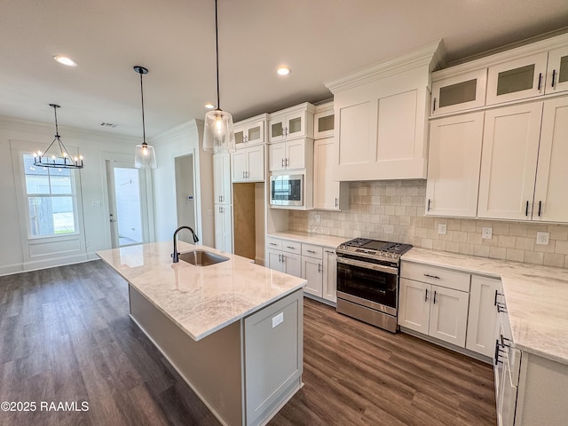 kitchen featuring backsplash, stainless steel appliances, light stone counters, and a sink