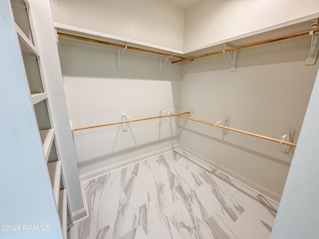 spacious closet with marble finish floor