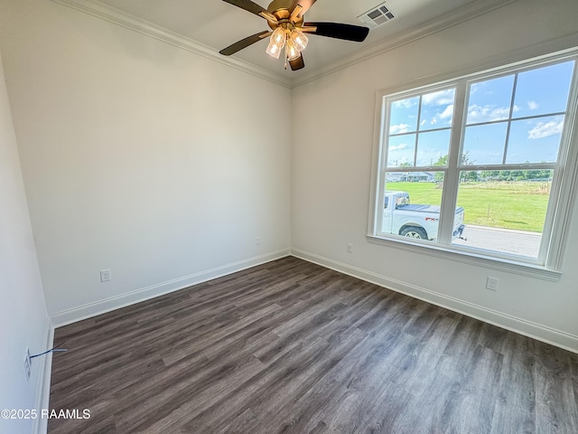 unfurnished room with baseboards, ornamental molding, dark wood-type flooring, and visible vents
