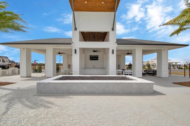 exterior space featuring ceiling fan, fence, a patio area, and an outdoor living space with a fire pit