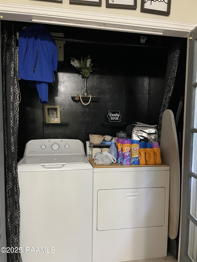 laundry area featuring separate washer and dryer and laundry area