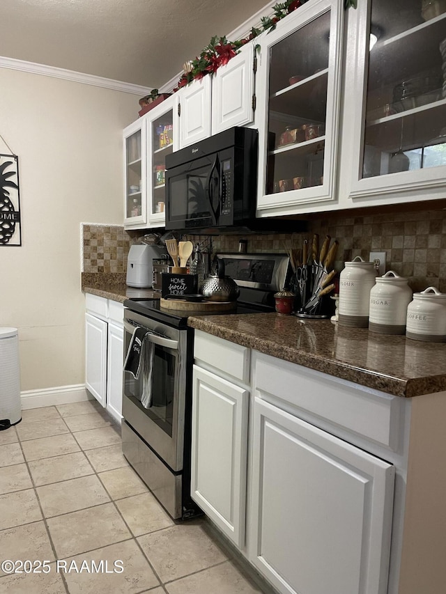 kitchen with ornamental molding, black microwave, decorative backsplash, white cabinets, and stainless steel range with electric cooktop