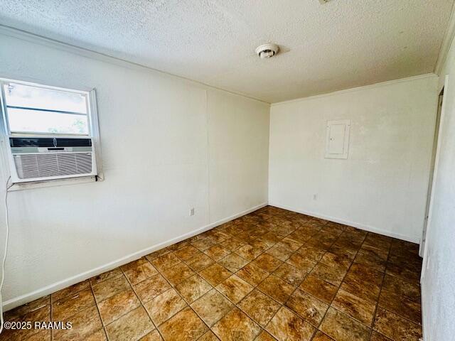321 S Academy St, Opelousas, LA 70570 - spare room featuring a textured ceiling, cooling unit, crown molding, and baseboards