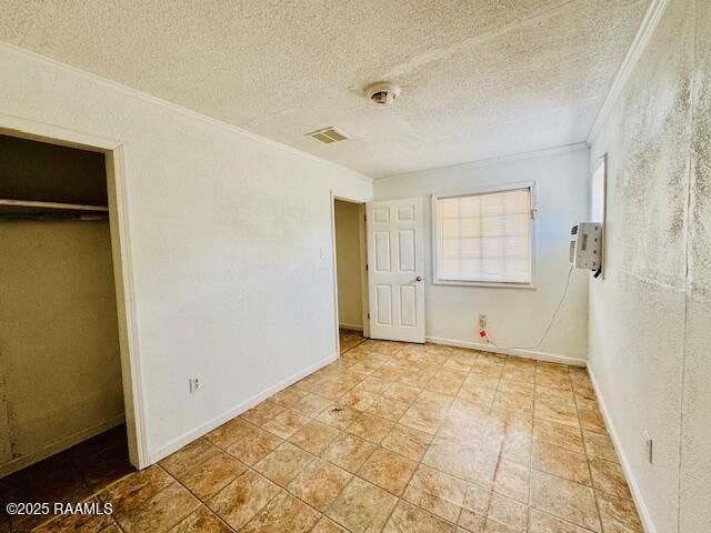 321 S Academy St, Opelousas, LA 70570 - unfurnished bedroom featuring ornamental molding, a textured ceiling, and baseboards