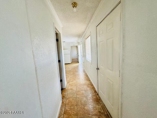 321 S Academy St, Opelousas, LA 70570 - hall featuring ornamental molding, a textured ceiling, baseboards, and a textured wall