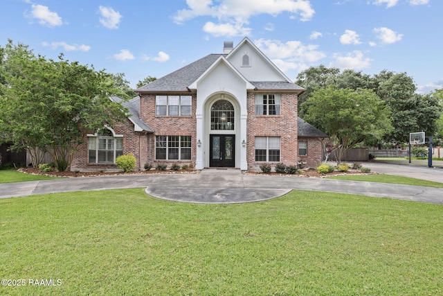 6 Oak Pl, New Iberia, LA 70563 - traditional-style home featuring brick siding, curved driveway, french doors, and a front yard