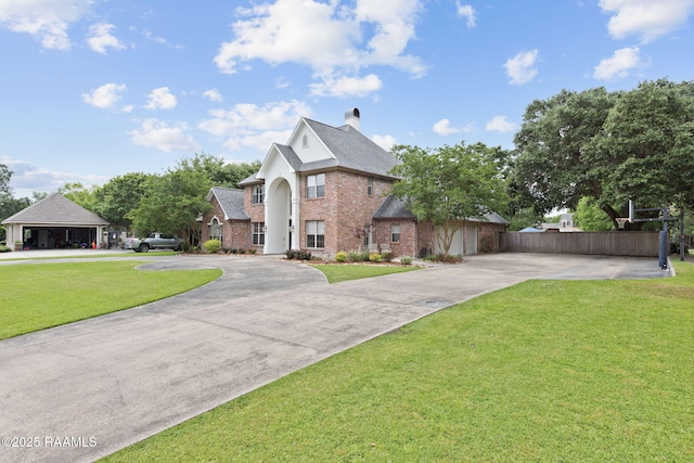 6 Oak Pl, New Iberia, LA 70563 - view of front of house featuring a chimney, brick siding, curved driveway, fence, and a front lawn