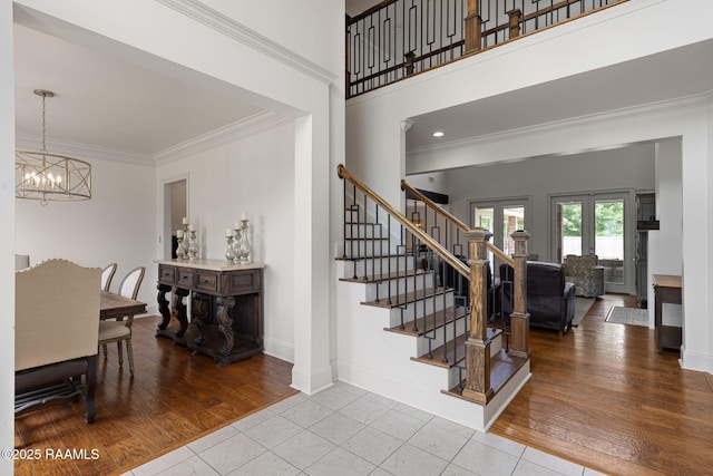 6 Oak Pl, New Iberia, LA 70563 - stairway featuring crown molding, baseboards, tile patterned flooring, and a notable chandelier