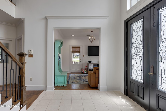6 Oak Pl, New Iberia, LA 70563 - entryway with crown molding, tile patterned floors, a notable chandelier, and stairway
