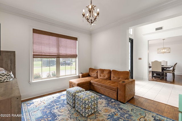 6 Oak Pl, New Iberia, LA 70563 - living area featuring visible vents, ornamental molding, wood finished floors, and a chandelier