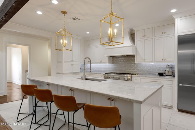 6 Oak Pl, New Iberia, LA 70563 - kitchen featuring backsplash, visible vents, a sink, built in refrigerator, and a chandelier