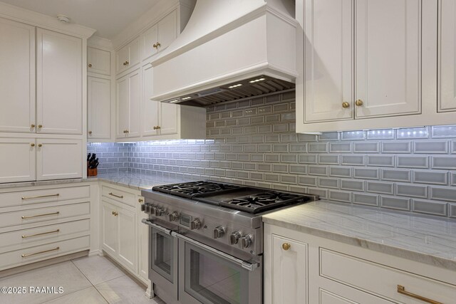 6 Oak Pl, New Iberia, LA 70563 - kitchen featuring backsplash, range with two ovens, light stone counters, white cabinets, and custom range hood