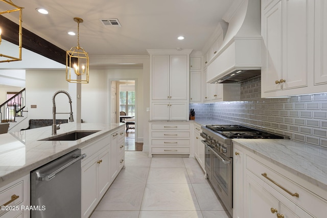 6 Oak Pl, New Iberia, LA 70563 - kitchen featuring premium range hood, white cabinetry, a sink, backsplash, and stainless steel appliances
