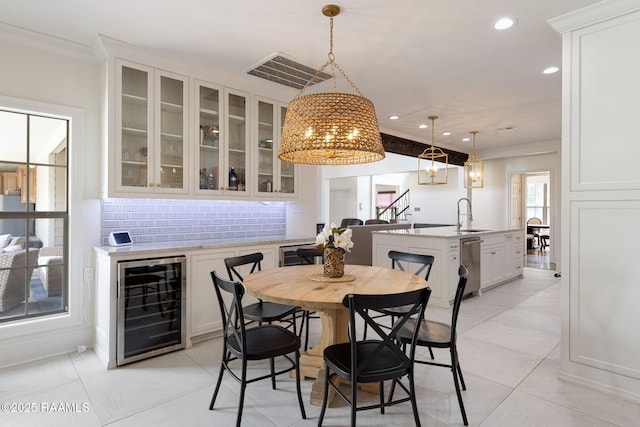 6 Oak Pl, New Iberia, LA 70563 - dining room with crown molding, a notable chandelier, beverage cooler, and visible vents
