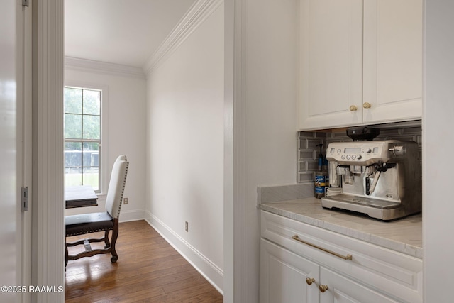 6 Oak Pl, New Iberia, LA 70563 - bar featuring baseboards, ornamental molding, decorative backsplash, and wood finished floors