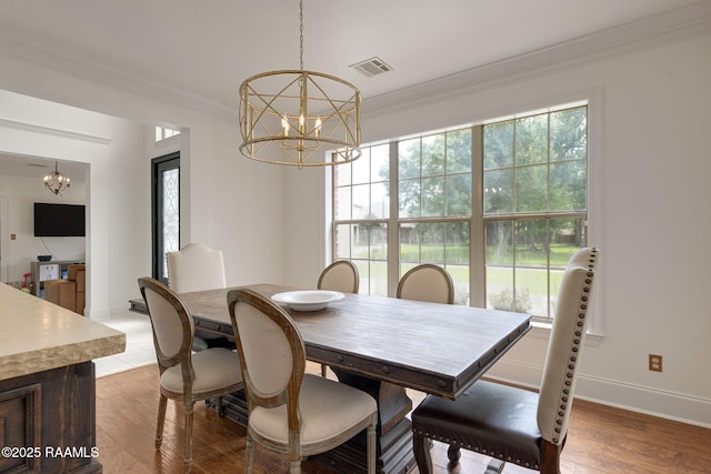 6 Oak Pl, New Iberia, LA 70563 - dining space with an inviting chandelier, ornamental molding, visible vents, baseboards, and light wood-style flooring