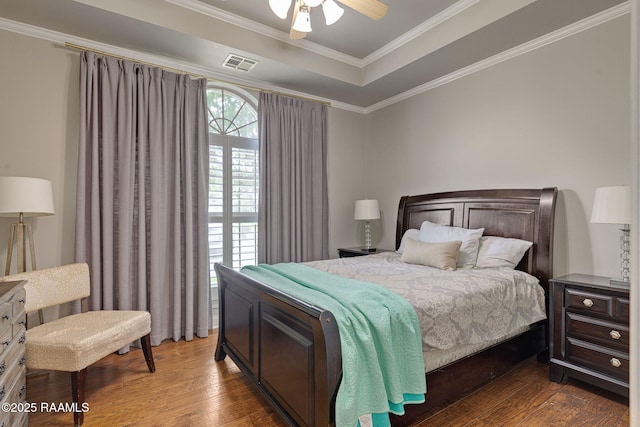 6 Oak Pl, New Iberia, LA 70563 - bedroom with visible vents, ornamental molding, a raised ceiling, hardwood / wood-style flooring, and a ceiling fan