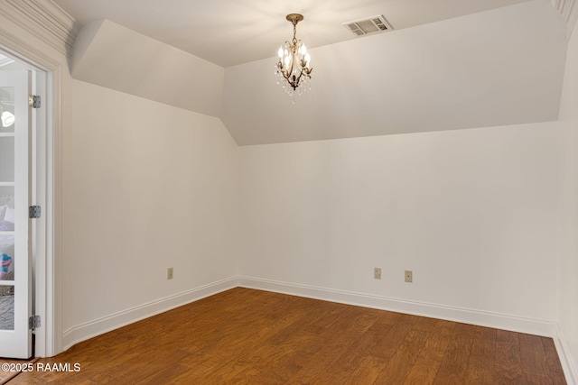 6 Oak Pl, New Iberia, LA 70563 - additional living space featuring visible vents, wood finished floors, baseboards, a notable chandelier, and vaulted ceiling