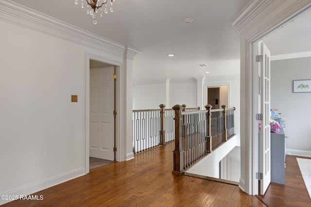 6 Oak Pl, New Iberia, LA 70563 - hallway featuring crown molding, baseboards, an upstairs landing, and wood finished floors