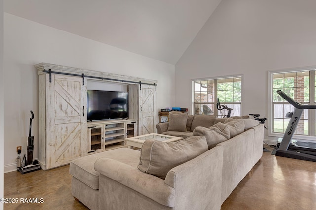 6 Oak Pl, New Iberia, LA 70563 - living room with baseboards, a barn door, finished concrete flooring, and high vaulted ceiling