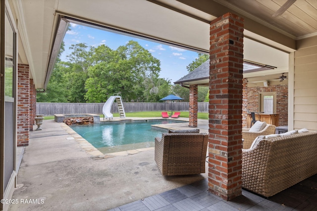 6 Oak Pl, New Iberia, LA 70563 - view of swimming pool featuring a water slide, a fenced in pool, a fenced backyard, a patio area, and a ceiling fan