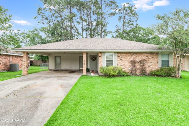 307 Creswell Ave, Scott, LA 70583 - ranch-style house featuring an attached carport, central AC, driveway, and a front lawn