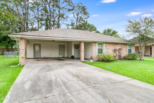 307 Creswell Ave, Scott, LA 70583 - single story home with fence, roof with shingles, a front lawn, an attached carport, and driveway