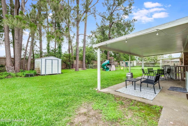 307 Creswell Ave, Scott, LA 70583 - view of yard featuring an outbuilding, a patio area, a fenced backyard, a shed, and a playground