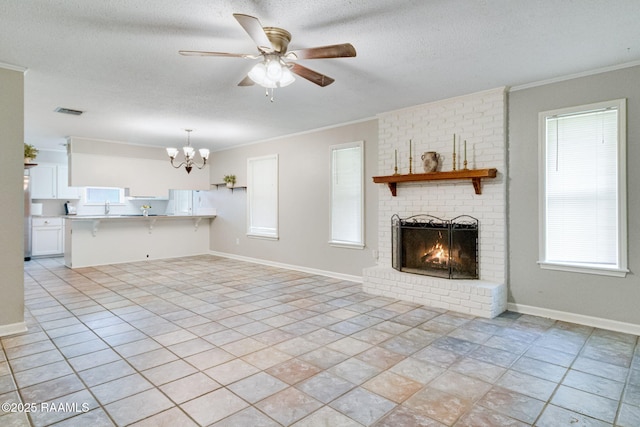 307 Creswell Ave, Scott, LA 70583 - unfurnished living room with ornamental molding, a brick fireplace, ceiling fan with notable chandelier, and a wealth of natural light