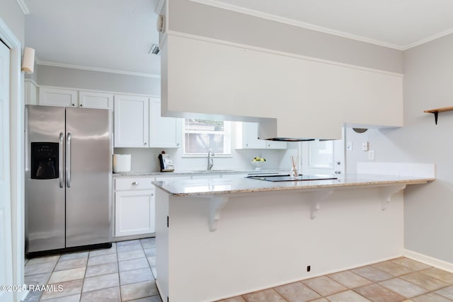 307 Creswell Ave, Scott, LA 70583 - kitchen featuring a sink, stainless steel fridge with ice dispenser, light stone counters, a peninsula, and white cabinetry